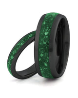 Matching black tungsten wedding rings with green emerald stone inlays