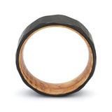 Side profile of a black geometric tungsten whiskey barrel wedding ring with reclaimed oak wood.