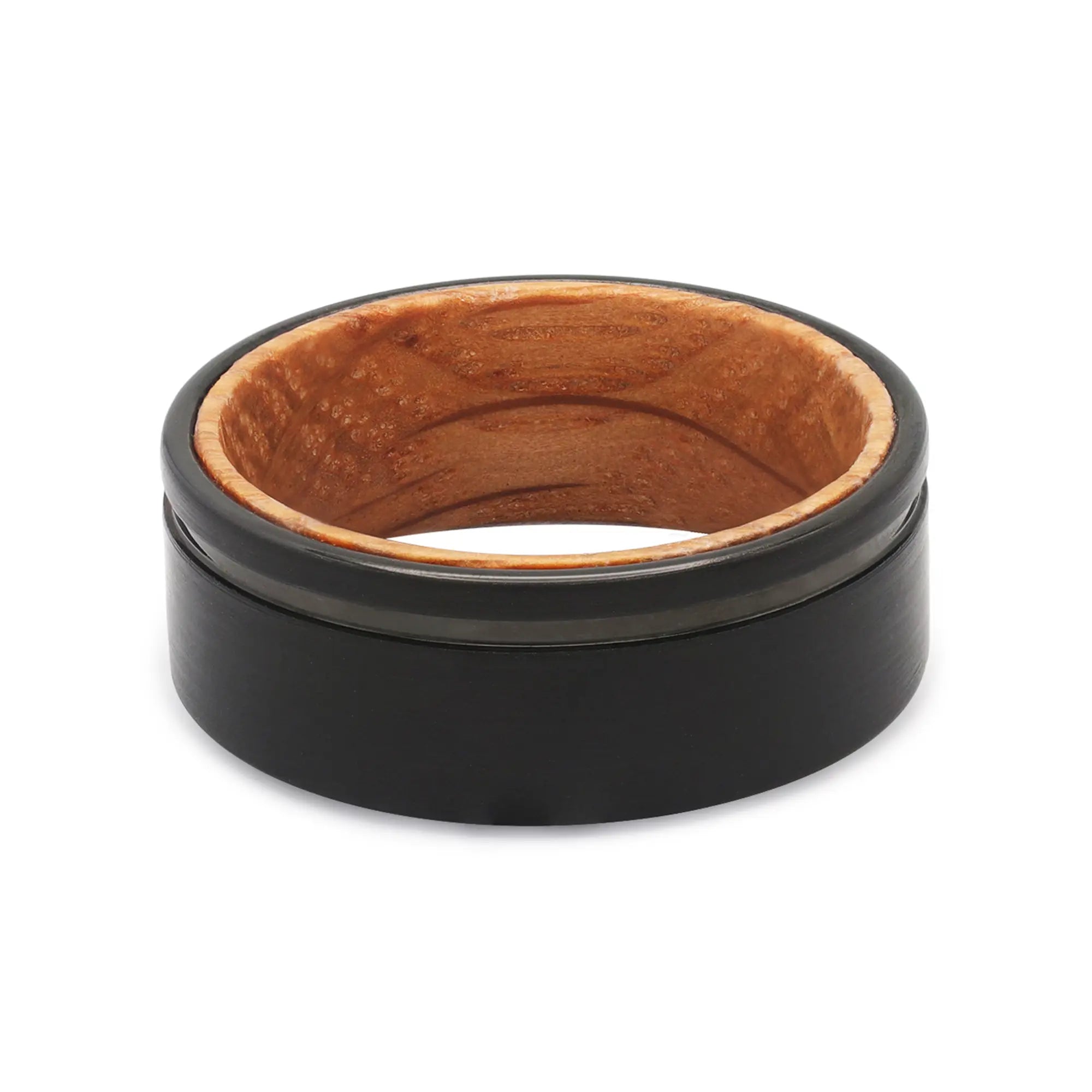 Top view of a black groove tungsten wedding ring with a real oak whiskey barrel wood interior.