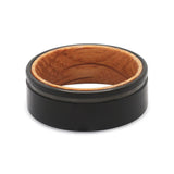 Top view of a black groove tungsten wedding ring with a real oak whiskey barrel wood interior.
