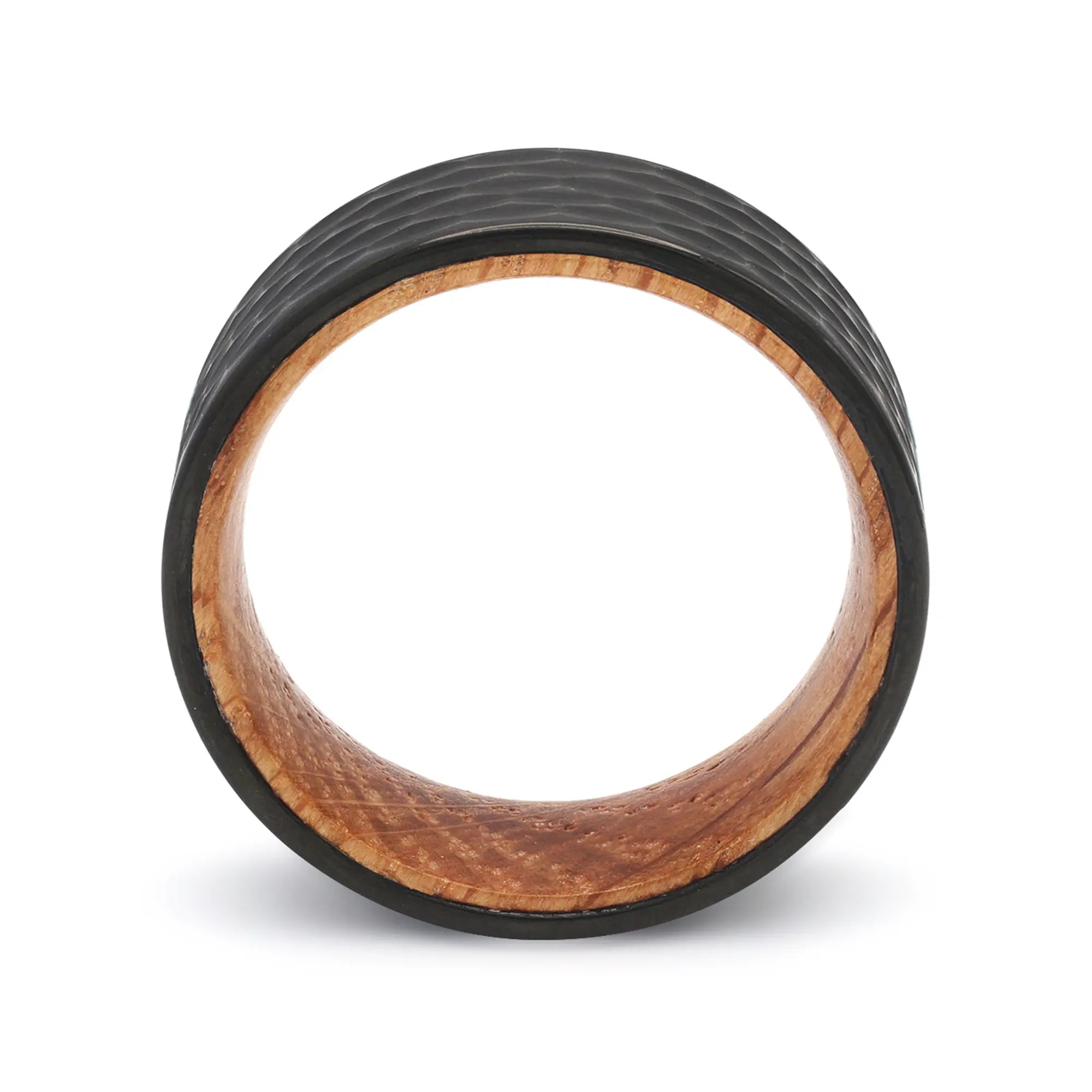 Side profile of a black hammered tungsten whiskey barrel wedding ring with a reclaimed oak wood interior.