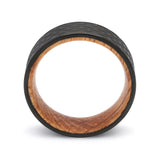 Side profile of a black hammered tungsten whiskey barrel wedding ring with a reclaimed oak wood interior.
