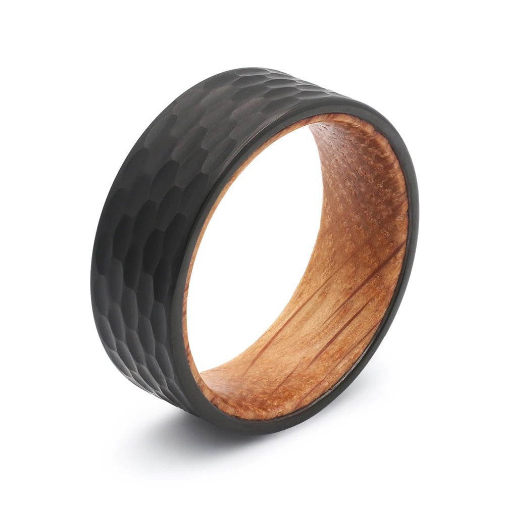Black hammered tungsten whiskey barrel wedding ring with a real oak wood interior.