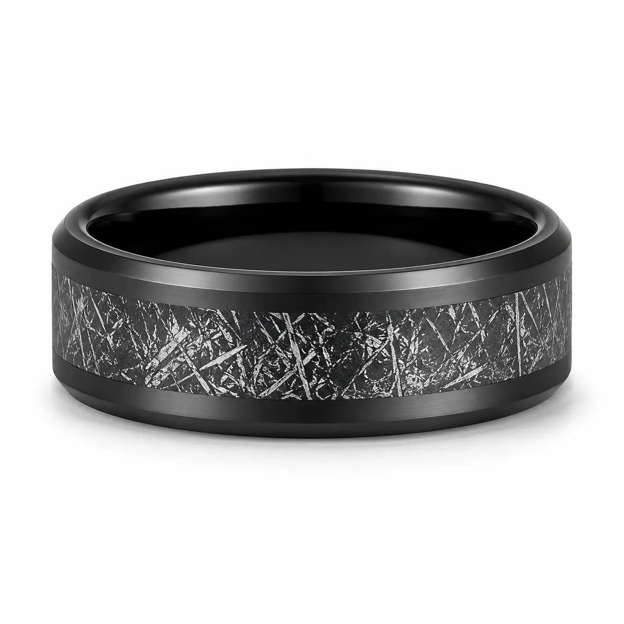 Black tungsten wedding ring with a meteorite inspired textured inlay lying flat on a white studio background, showing the full width of the band and polished comfort fit interior.