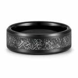 Black tungsten wedding ring with a meteorite inspired textured inlay lying flat on a white studio background, showing the full width of the band and polished comfort fit interior.