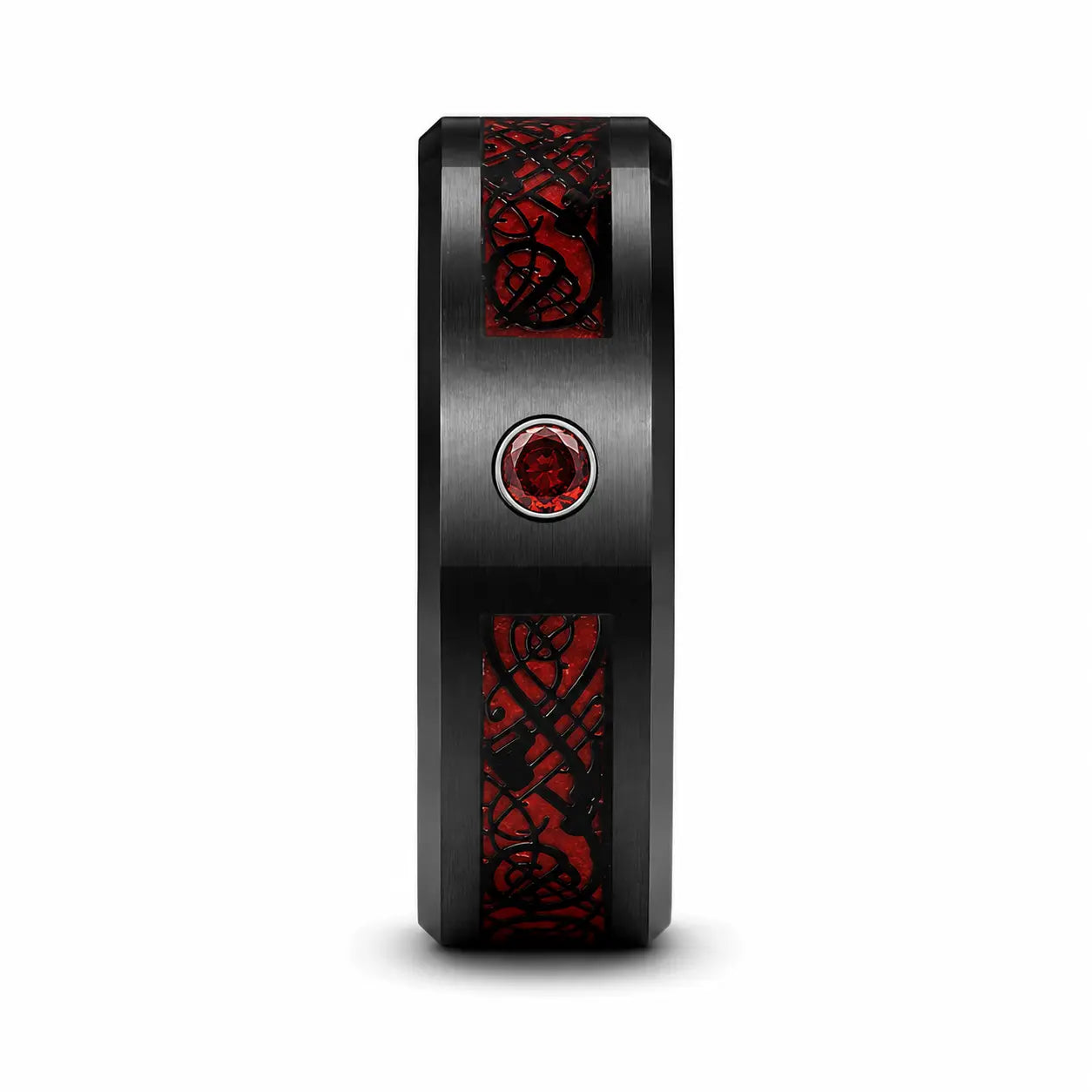 Side profile of a black tungsten wedding ring with a brushed finish, red Celtic dragon inlay and red gemstone on a white studio background.