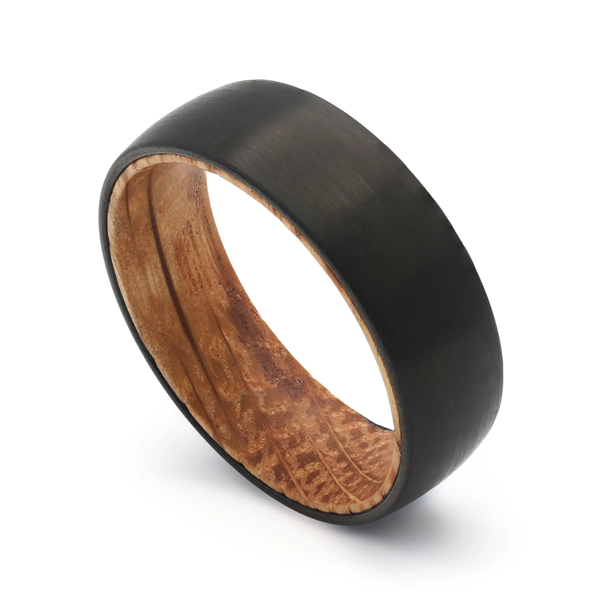 Angled view of a black tungsten whiskey barrel wedding ring with a real oak wood interior.