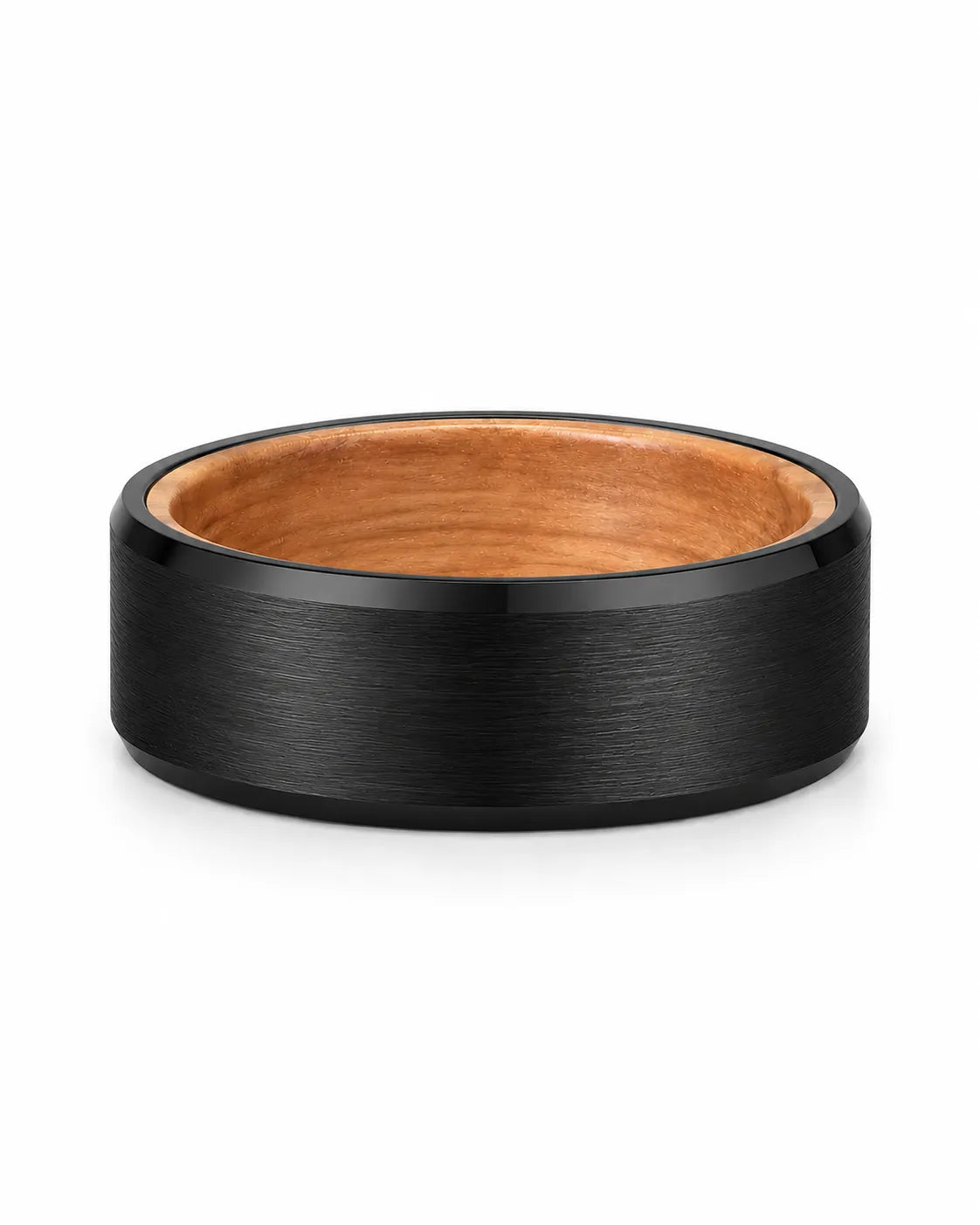 Black brushed tungsten wedding ring with polished beveled edges and a whiskey barrel wood interior photographed from a low front angle on a white background.