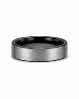 Brushed silver and black tungsten wedding ring lying flat