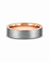 Brushed silver and rose gold tungsten wedding ring lying flat