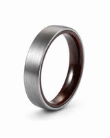 Brushed silver tungsten wedding ring with a maple wood sleeve interior shown at an angled view on a white background.