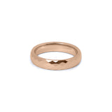 Modern rose gold womens eternity band ring with light-reflecting facets
