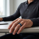 man wearing a blue polished tungsten wedding ring