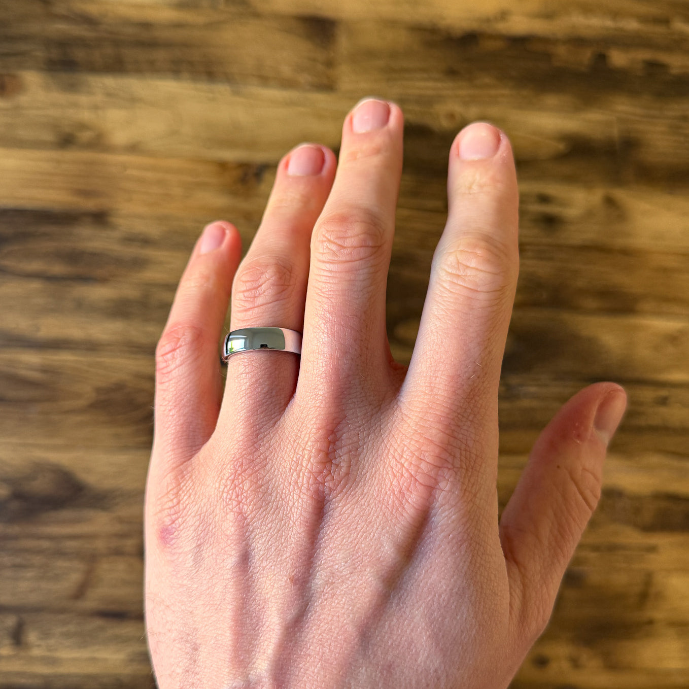 classic mens polished tungsten wedding ring on hand