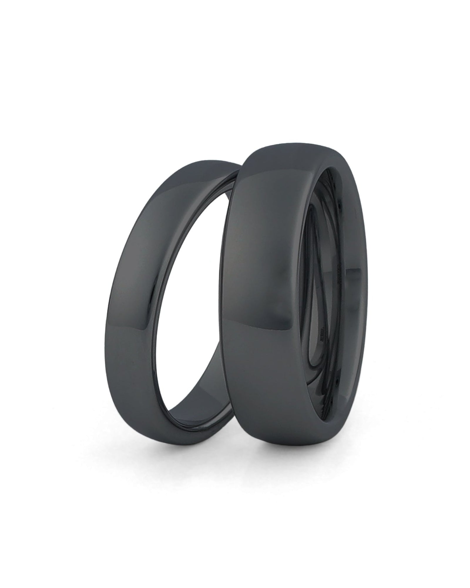 black wedding ring sets his and hers on white background