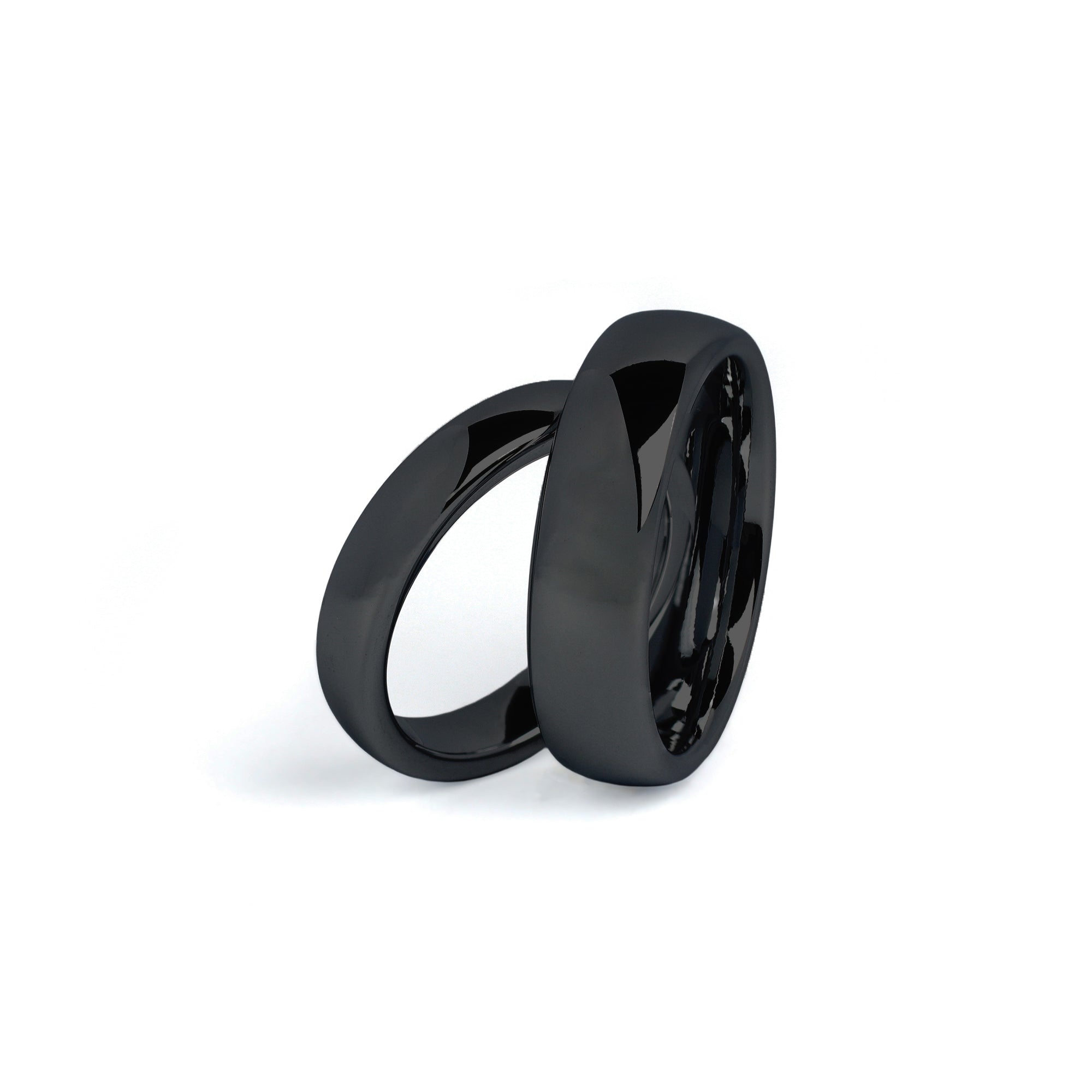 black wedding ring sets his and hers on white background