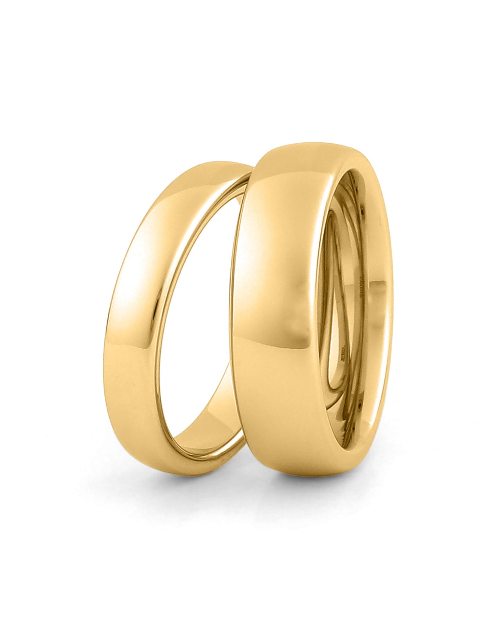 His and hers gold wedding rings set on white background