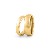 His and hers gold wedding rings set on white background