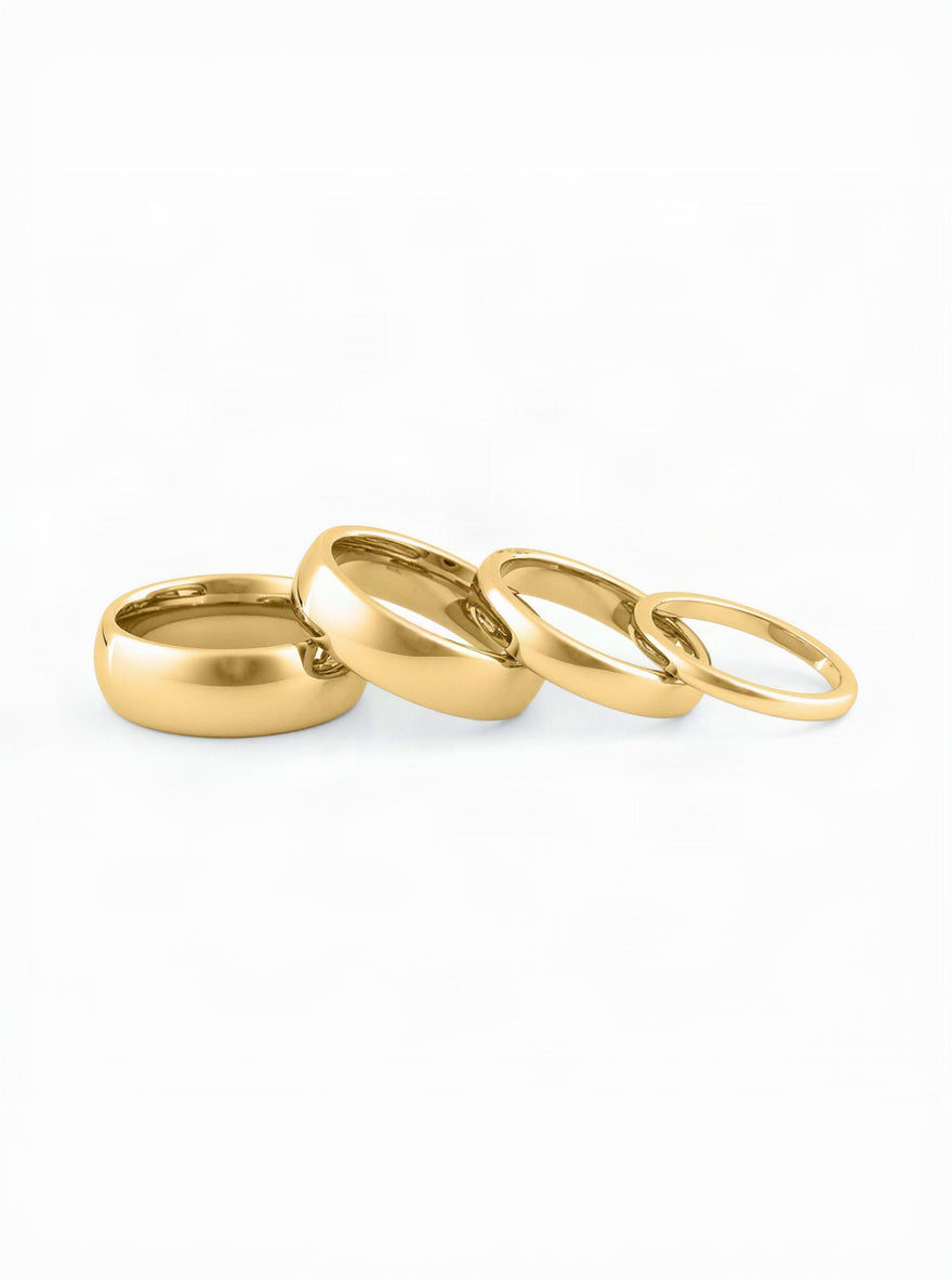Comfort fit gold wedding bands for couples on white backdrop