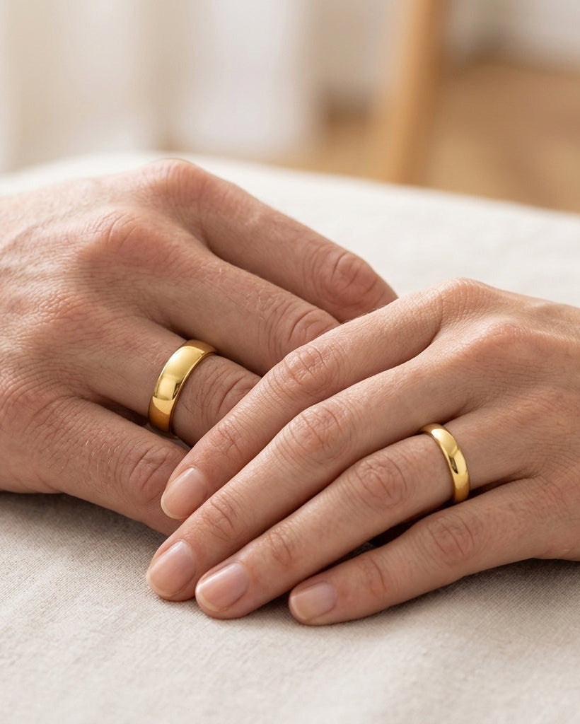 His and hers gold wedding rings set on hands