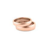 Set of matching rose gold wedding rings for engaged couples, polished and durable