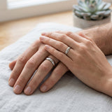 couple wearing matching silver tungsten wedding rings