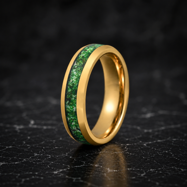 Gold ring with green inlay on a dark textured surface
