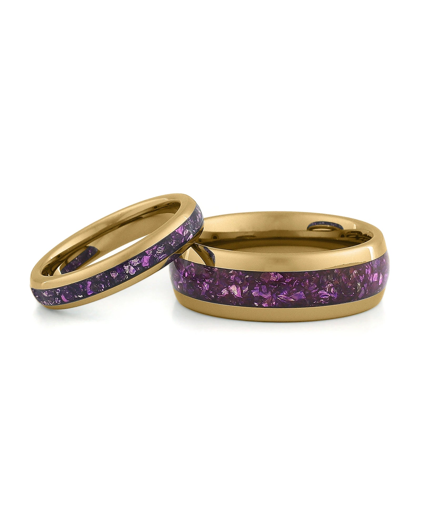 Matching gold wedding bands with purple amethyst stone inlays