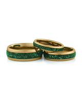 Gold emerald tungsten couples wedding ring set shown together