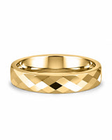 Gold faceted tungsten wedding ring lying flat, showing the diamond-cut finish