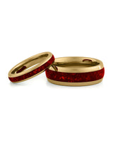 Matching gold wedding bands with red ruby stone inlays