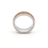 a side view showing a silver tungsten ring with an inlay of wood and guitar strings