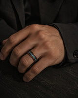 man wearing a Koa wood and abalone shell tungsten ring with polished gunmetal finish