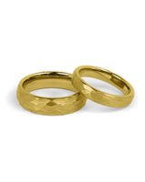Matching gold tungsten wedding bands with hammered finish