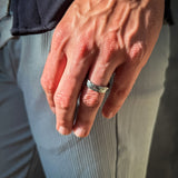 a man wearing a hammered grey tungsten wedding band
