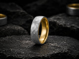 Luxury lifestyle close-up of a man wearing a hammered silver and gold wedding ring with a modern masculine aesthetic.