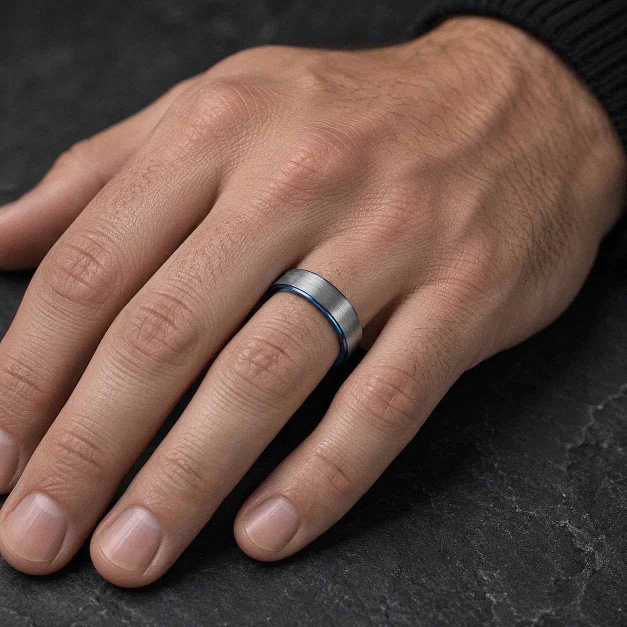 Man wearing an 6mm brushed silver tungsten wedding ring with polished blue inner band