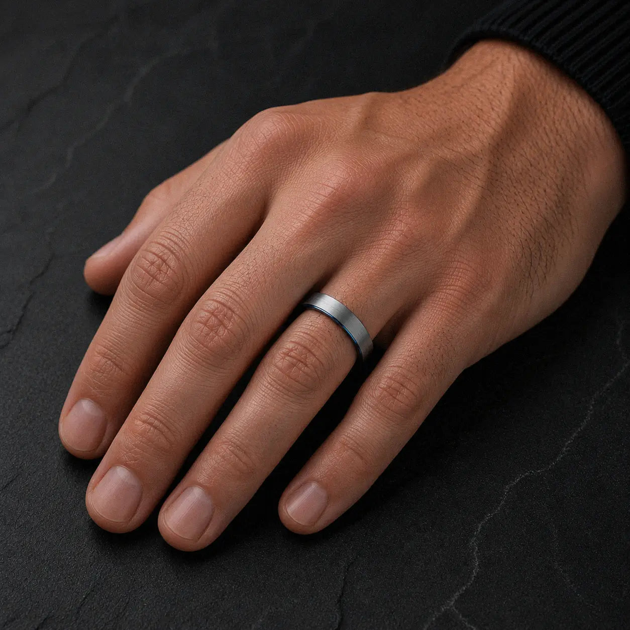 Man wearing an 4mm brushed silver tungsten wedding ring with polished blue inner band