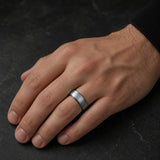 Man wearing an 8mm brushed silver tungsten wedding ring with polished blue inner band