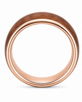 Side profile of a wide men’s ring with a reddish-brown wood centre and polished rose gold edges.