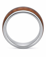 Side profile of a wide men’s ring with a reddish-brown wood centre and polished silver edges.