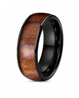 Men’s polished black ring with a reddish-brown wood inlay, standing upright on a white background.