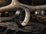 Men’s black tungsten antler wedding ring with natural deer antler interior