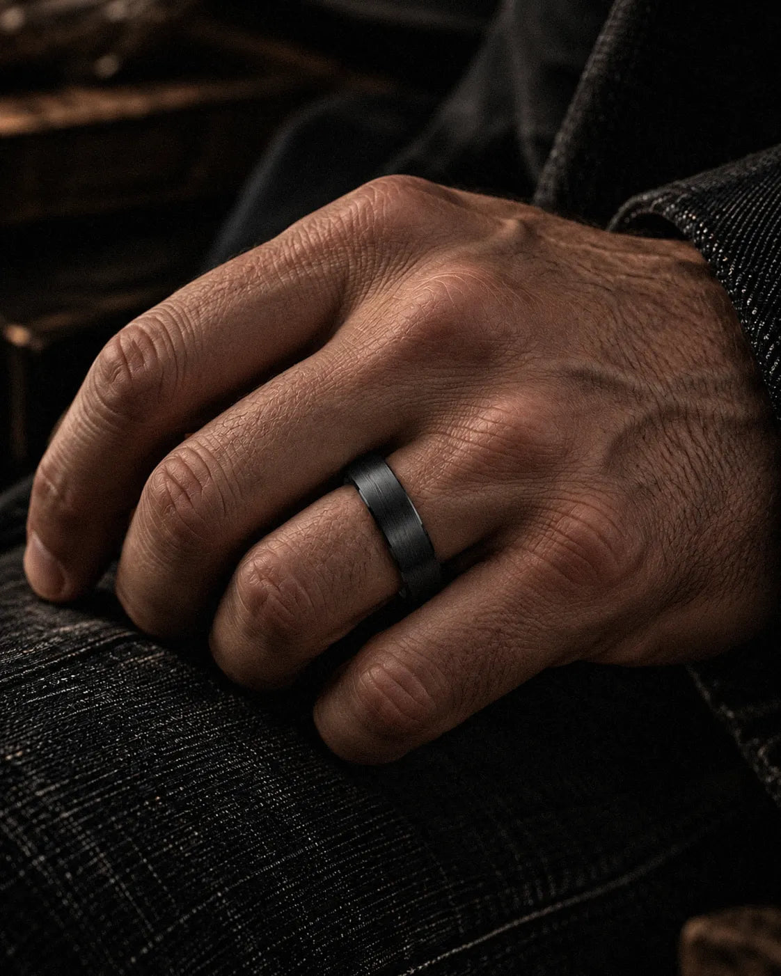 Man wearing a brushed black tungsten wedding ring with natural antler inner sleeve