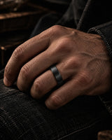 Man wearing a brushed black tungsten wedding ring with natural antler inner sleeve