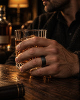 Man wearing a black hammered tungsten wedding ring with whiskey barrel wood interior