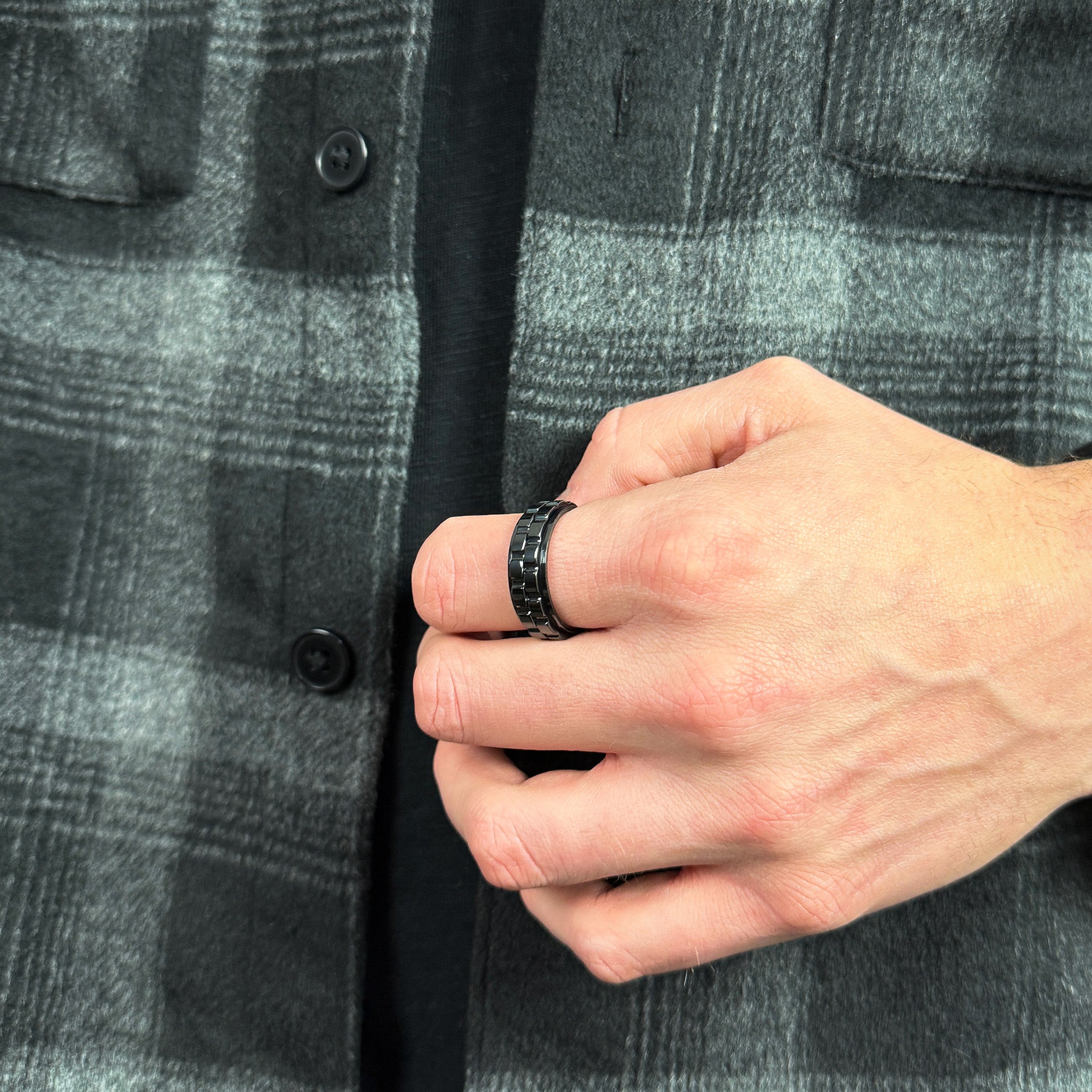man wearing a black spinning ring with gears for anxiety relief
