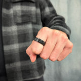 man wearing a black spinning ring with gears for anxiety relief