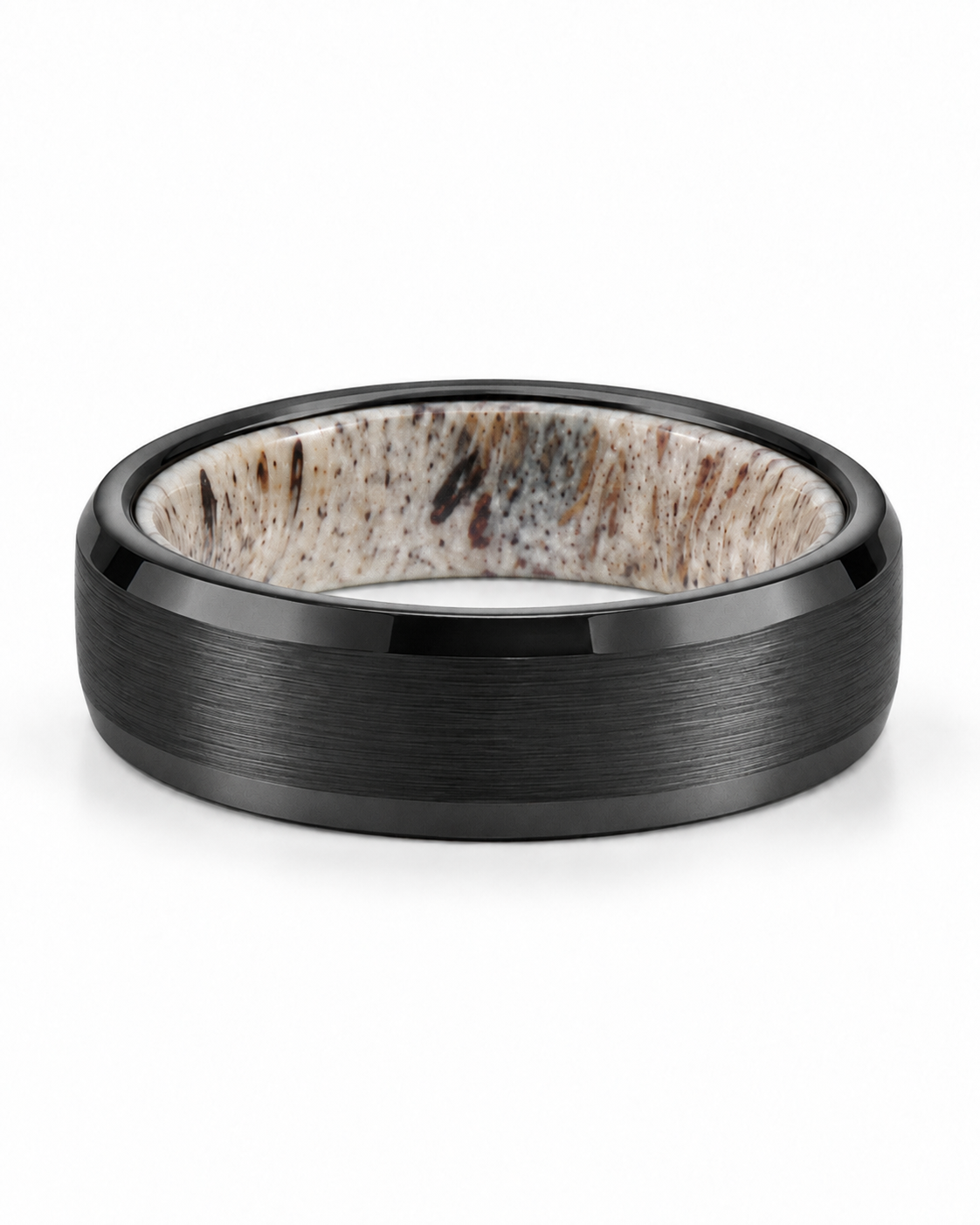 Brushed black tungsten wedding ring lying flat showing natural antler inner sleeve