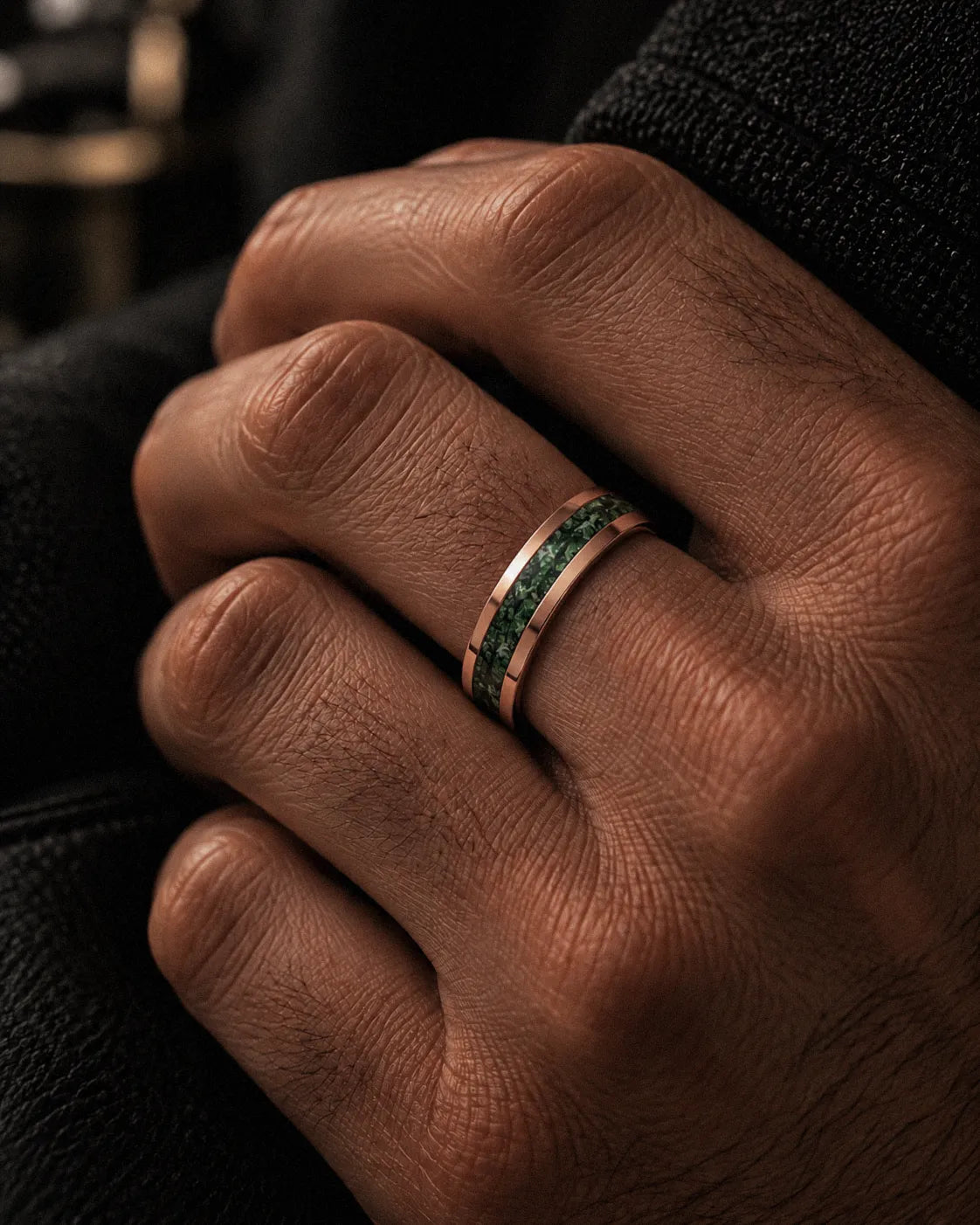 Man wearing a 6mm rose gold tungsten wedding ring with a natural green moss agate inlay.